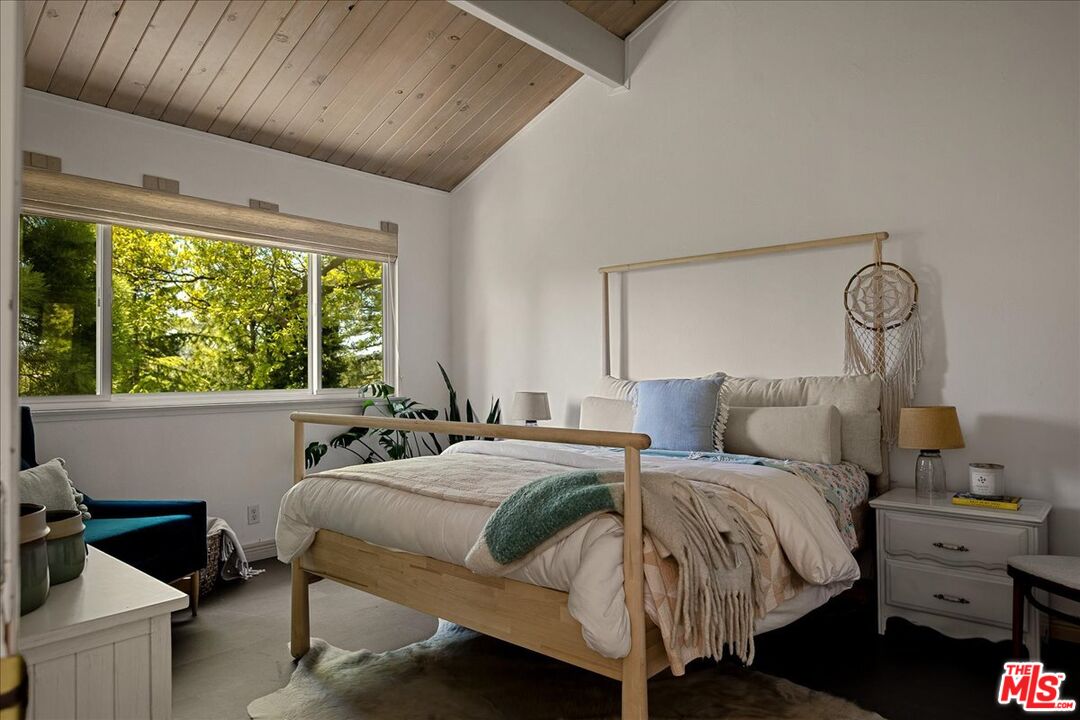 27975 St Bernard Lane Lake Arrowhead, CA 92352 - Photo 31 of 45 a bedroom with a bed and a large window