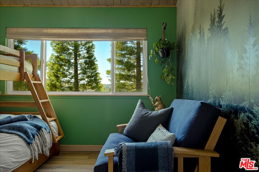 27975 St Bernard Lane Lake Arrowhead, CA 92352 - Photo 34 of 45 a view of a room that has a bed chair and a potted plant
