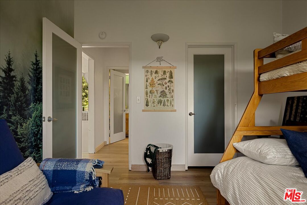 27975 St Bernard Lane Lake Arrowhead, CA 92352 - Photo 35 of 45 a bedroom with a bed and wooden floor