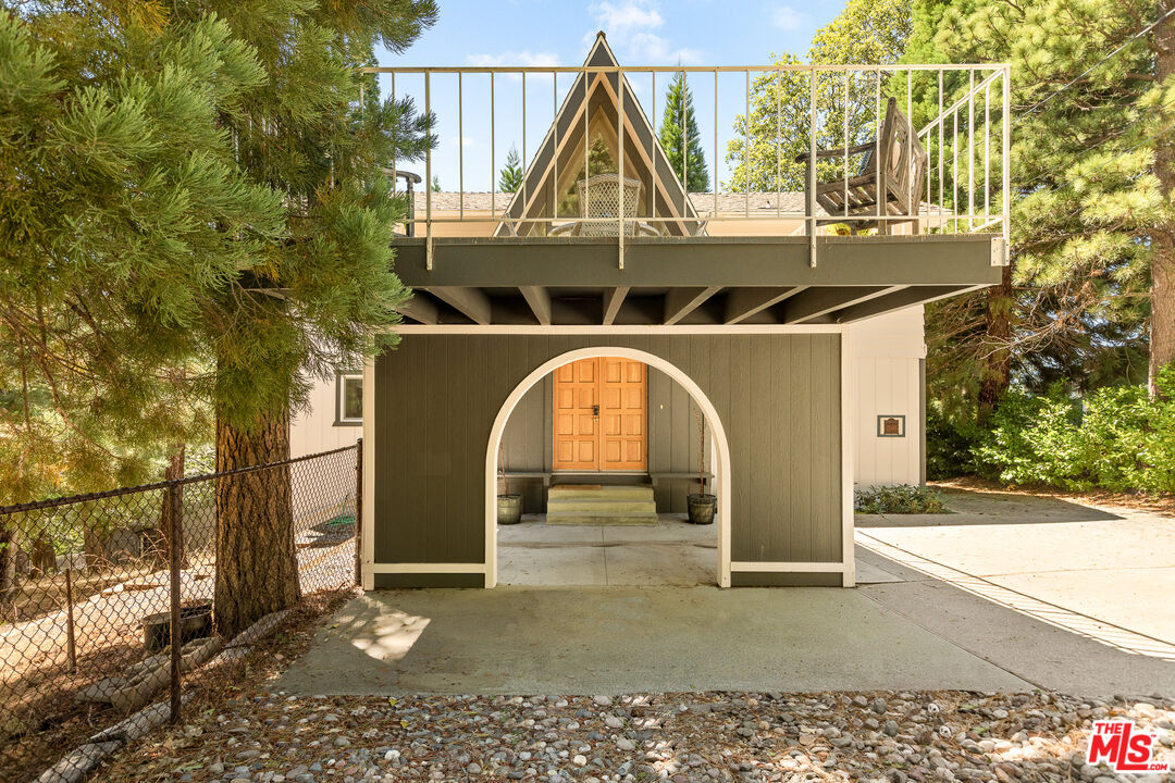 27975 St Bernard Lane Lake Arrowhead, CA 92352 - Photo 5 of 45 a front view of a house with garden