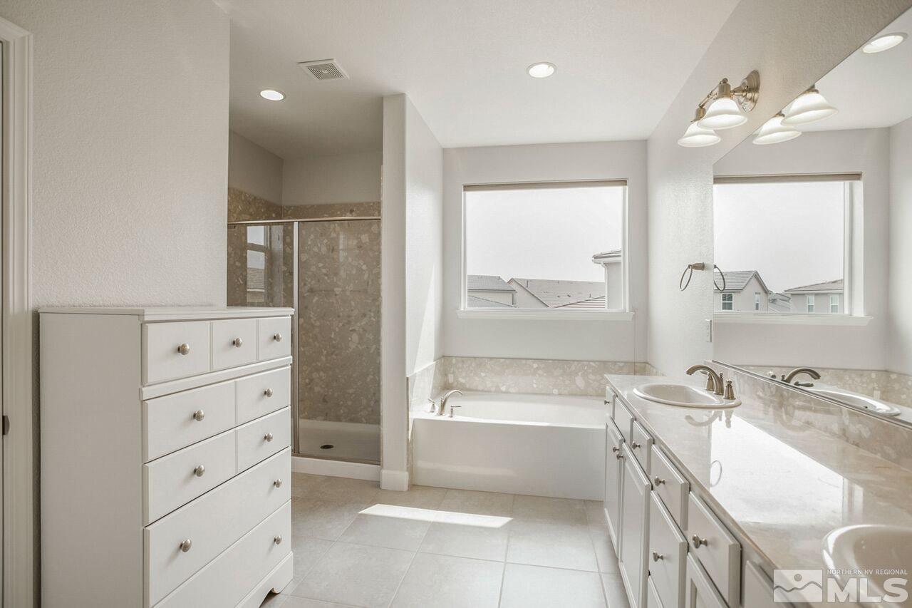 10370 Culiacan Pass Trail Reno, NV 89521 - Photo 20 of 25 a bathroom with a bathtub vanity and a sink