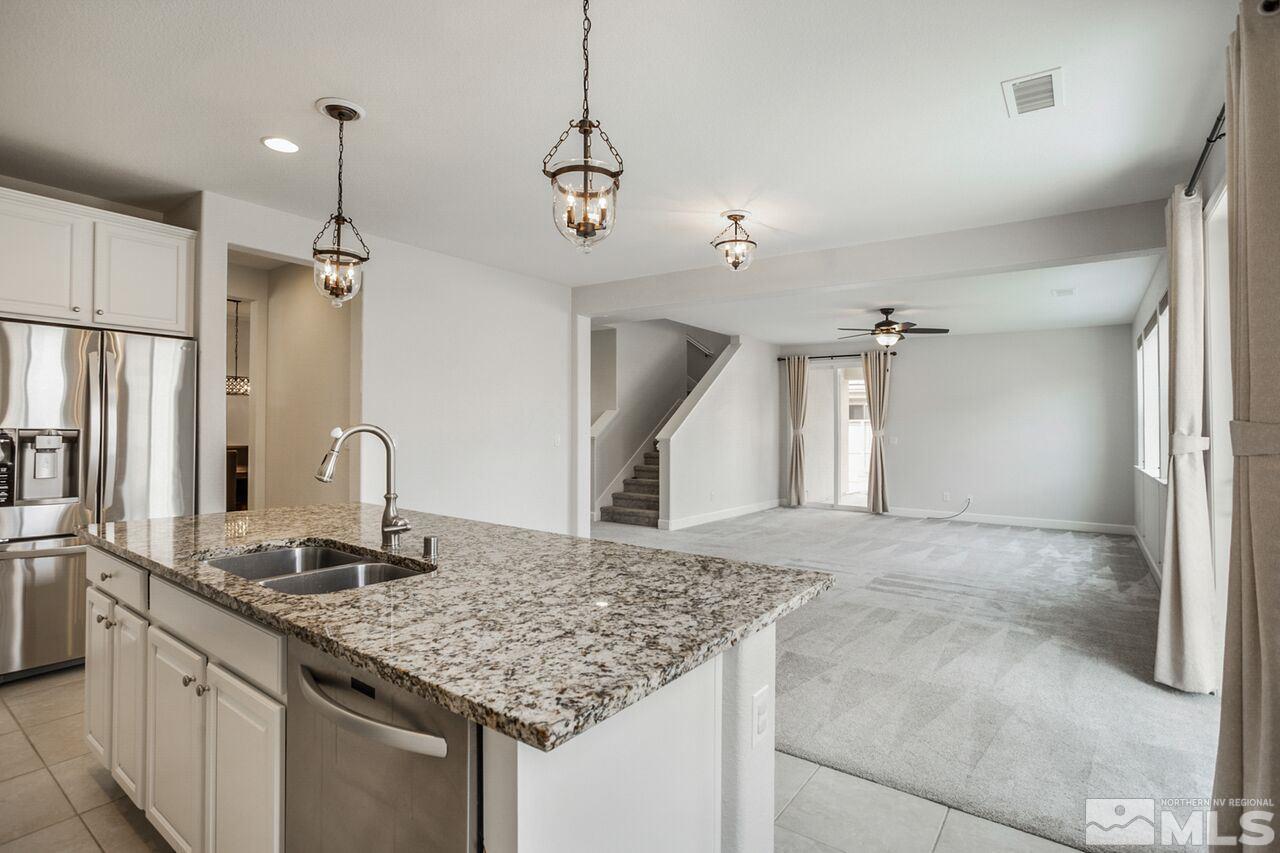 10370 Culiacan Pass Trail Reno, NV 89521 - Photo 6 of 25 a bathroom with a granite countertop sink and a mirror