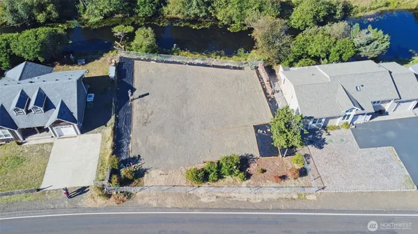 an aerial view of a house with yard and seating space
