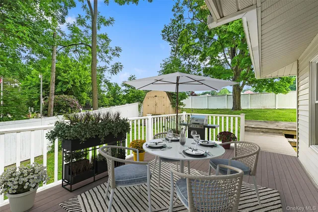 a view of a patio with furniture and a garden