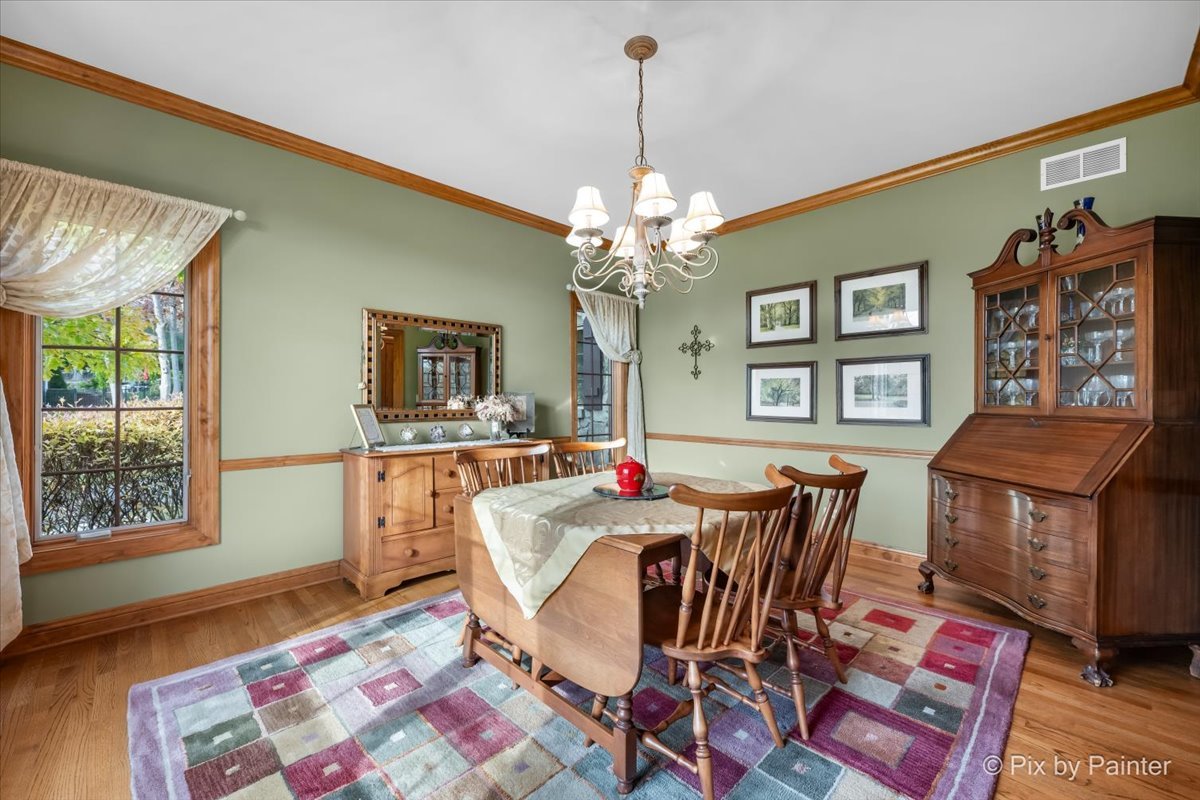 24881 North Black Walnut Cary, IL 60013 - Photo 11 of 53 a view of a dining room with furniture and a chandelier