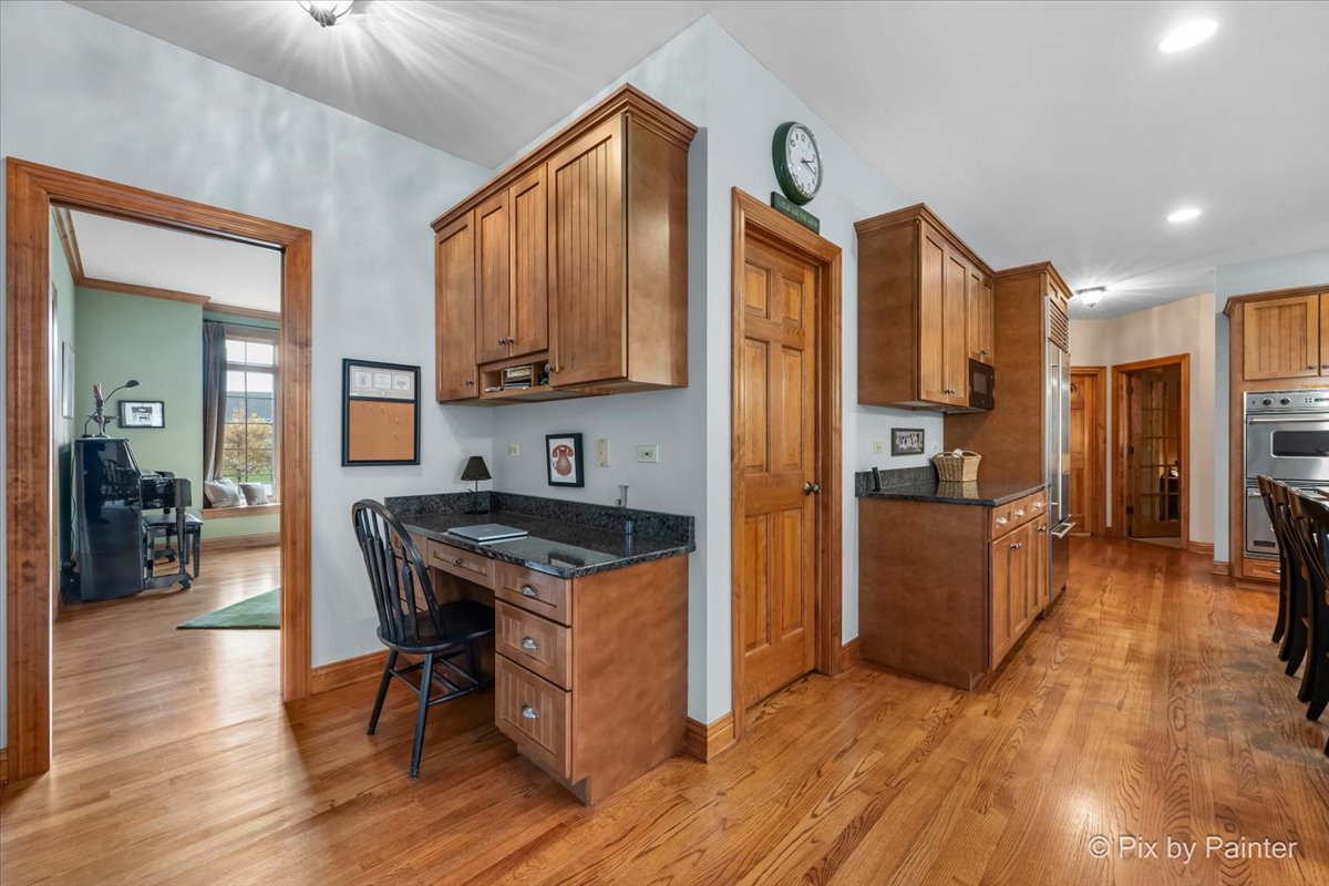 24881 North Black Walnut Cary, IL 60013 - Photo 20 of 53 a kitchen with stainless steel appliances granite countertop a refrigerator a stove and a wooden floors