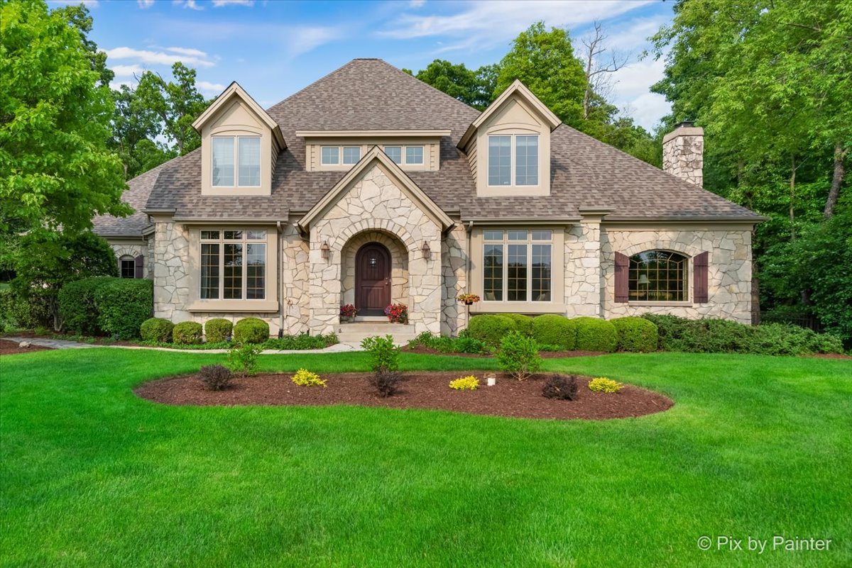 24881 North Black Walnut Cary, IL 60013 - Photo 2 of 53 a front view of a house with a yard and garage