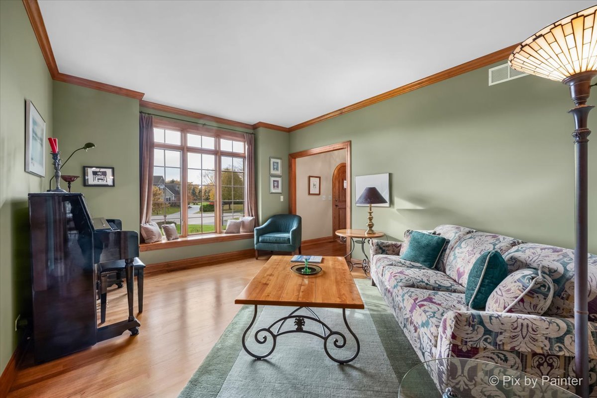 24881 North Black Walnut Cary, IL 60013 - Photo 21 of 53 a living room with furniture and a floor to ceiling window
