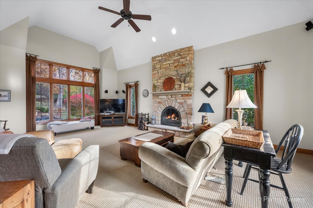 24881 North Black Walnut Cary, IL 60013 - Photo 23 of 53 a living room with furniture a large window and a fireplace