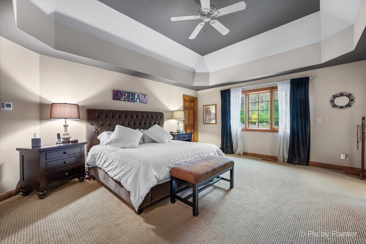 24881 North Black Walnut Cary, IL 60013 - Photo 28 of 53 a spacious bedroom with a bed and a chandelier