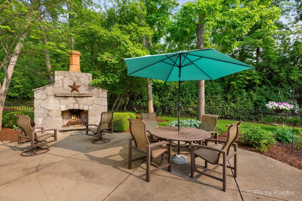 24881 North Black Walnut Cary, IL 60013 - Photo 6 of 53 a view of a patio with a table and chairs under an umbrella