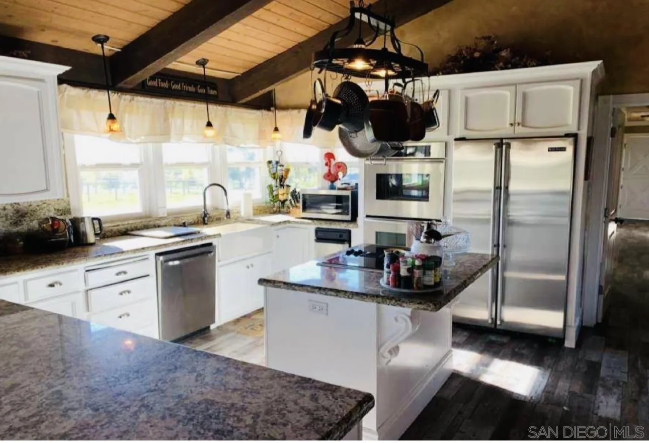 19901 Atkins Road Lodi, CA 95240 - Photo 10 of 27 a kitchen with stainless steel appliances granite countertop a sink a stove and a refrigerator