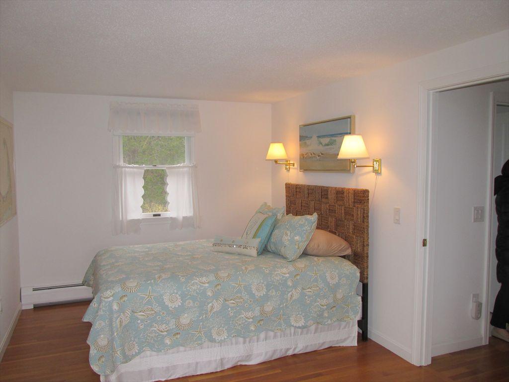 6 Snow Shore Road Orleans, MA 02653 - Photo 13 of 35 a bedroom with a bed and wooden floor