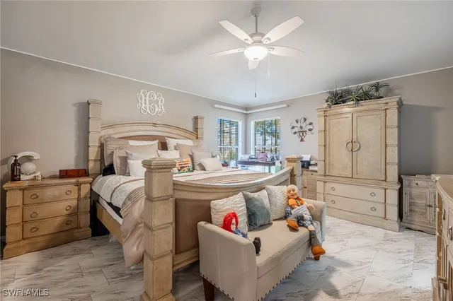 a bedroom with a large bed and a chandelier