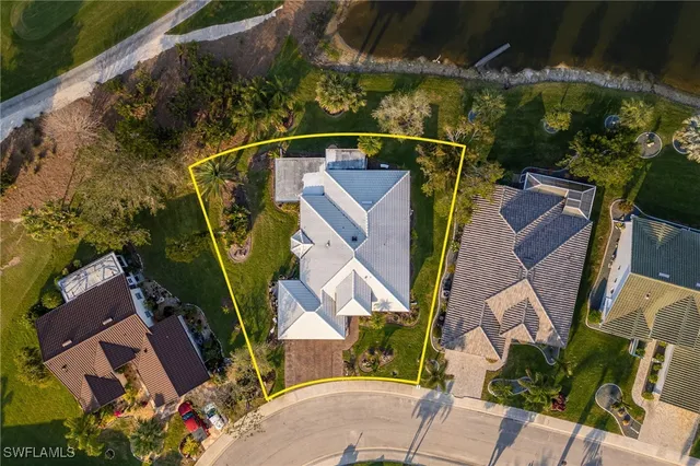 an aerial view of a house with a lake view