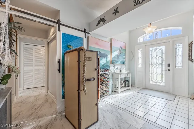 a living room with patio furniture and a large window