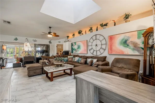a living room with lots of furniture and kitchen view