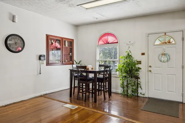 a view of a dining room with furniture window and wooden floor
