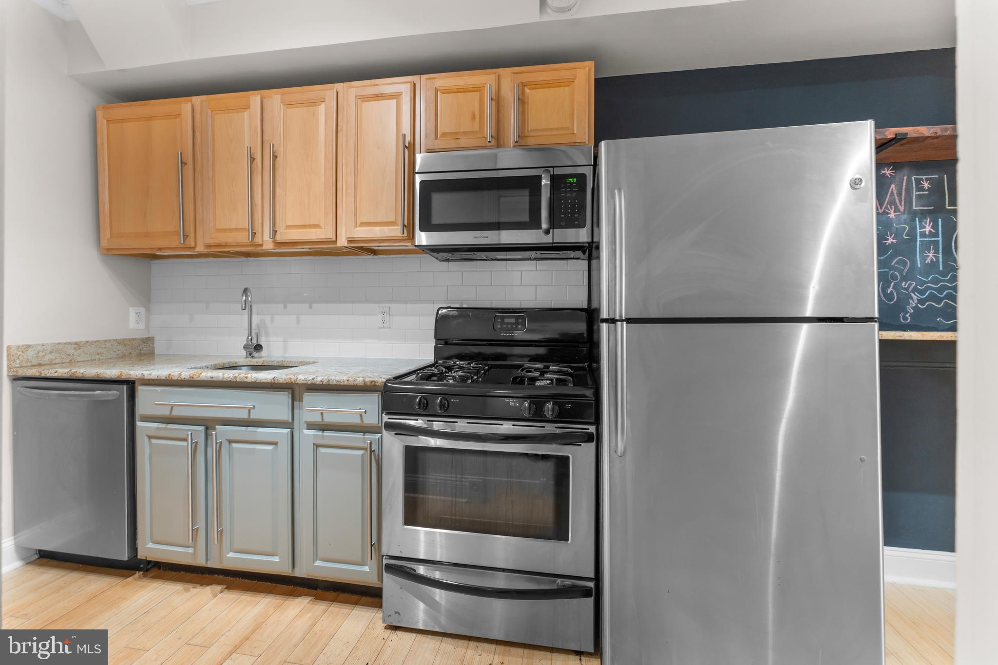550 Hobart Place Northwest, Unit 1 Washington, DC 20001 - Photo 13 of 22 a white refrigerator freezer and a stove top oven