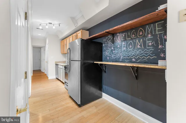 a view of a hallway with wooden floor