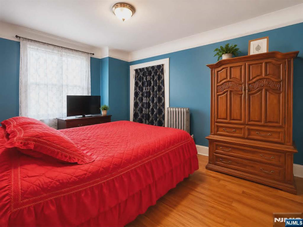 102 State Street Bloomfield, NJ 07003 - Photo 9 of 11 a bed sitting in a bedroom next to a window