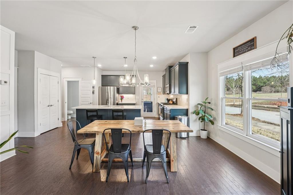 5175 North Pratt Street Covington, GA 30014 - Photo 14 of 52 a view of a dining room with furniture window and wooden floor