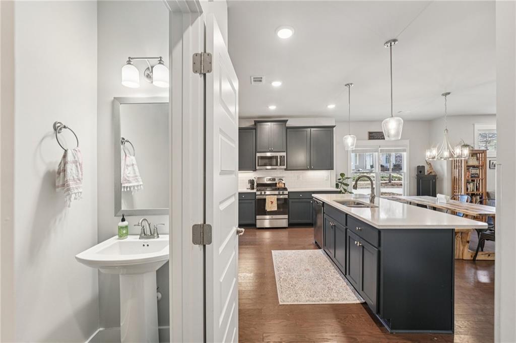 5175 North Pratt Street Covington, GA 30014 - Photo 27 of 52 a kitchen with stainless steel appliances kitchen island a sink and a refrigerator