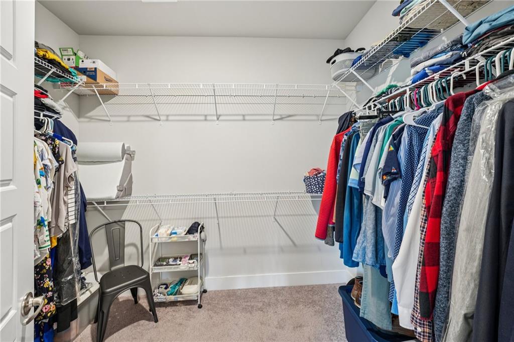 5175 North Pratt Street Covington, GA 30014 - Photo 33 of 52 a view of walk in closet with clothes and shoes