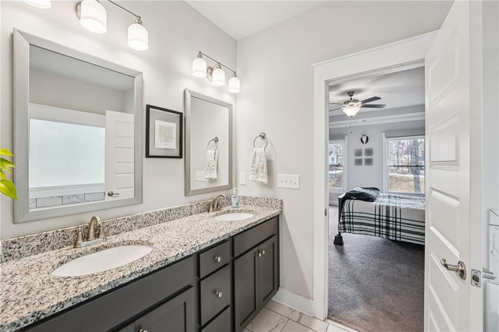 5175 North Pratt Street Covington, GA 30014 - Photo 34 of 52 a en suite bathroom with double sink and a mirror