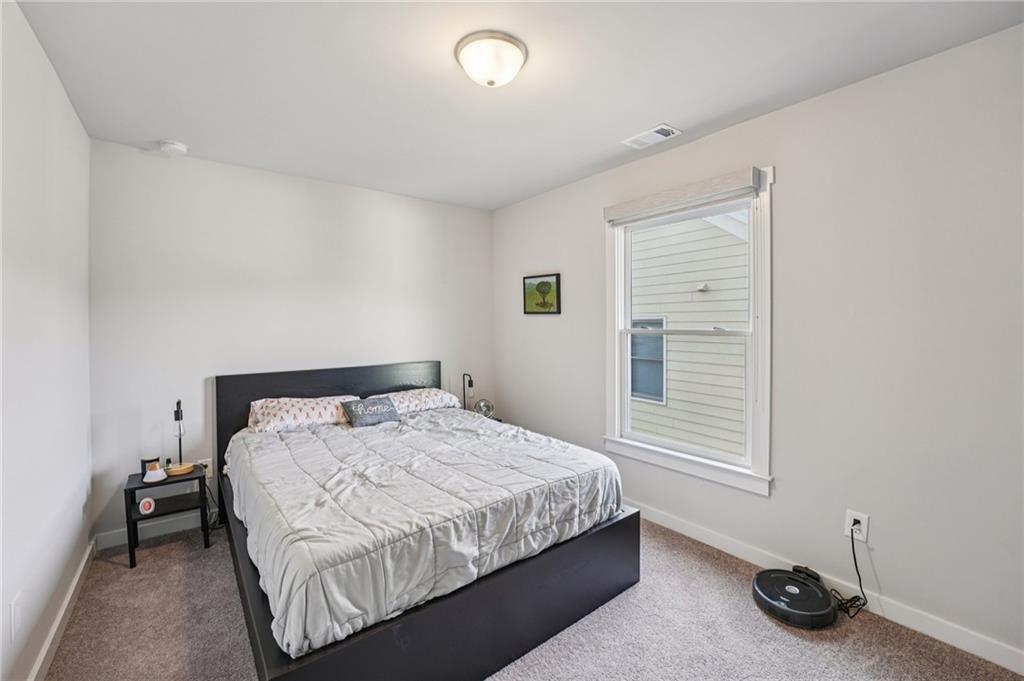 5175 North Pratt Street Covington, GA 30014 - Photo 37 of 52 a bedroom with a bed and a window