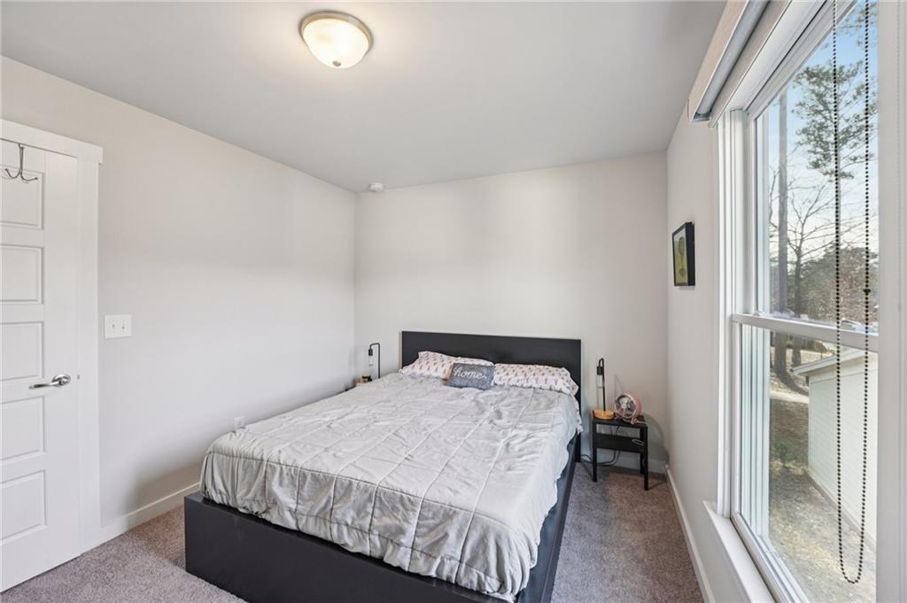 5175 North Pratt Street Covington, GA 30014 - Photo 38 of 52 a bedroom with a bed and a large window