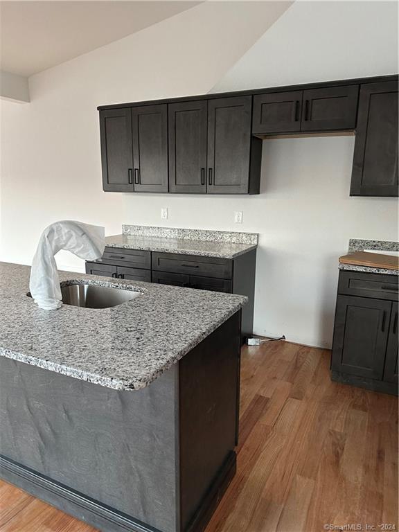 3 Banner Road, Unit 101 East Haddam, CT 06469 - Photo 13 of 19 a kitchen with granite countertop a sink a stove and cabinets