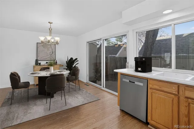 a kitchen with a dining table chairs and granite counter tops