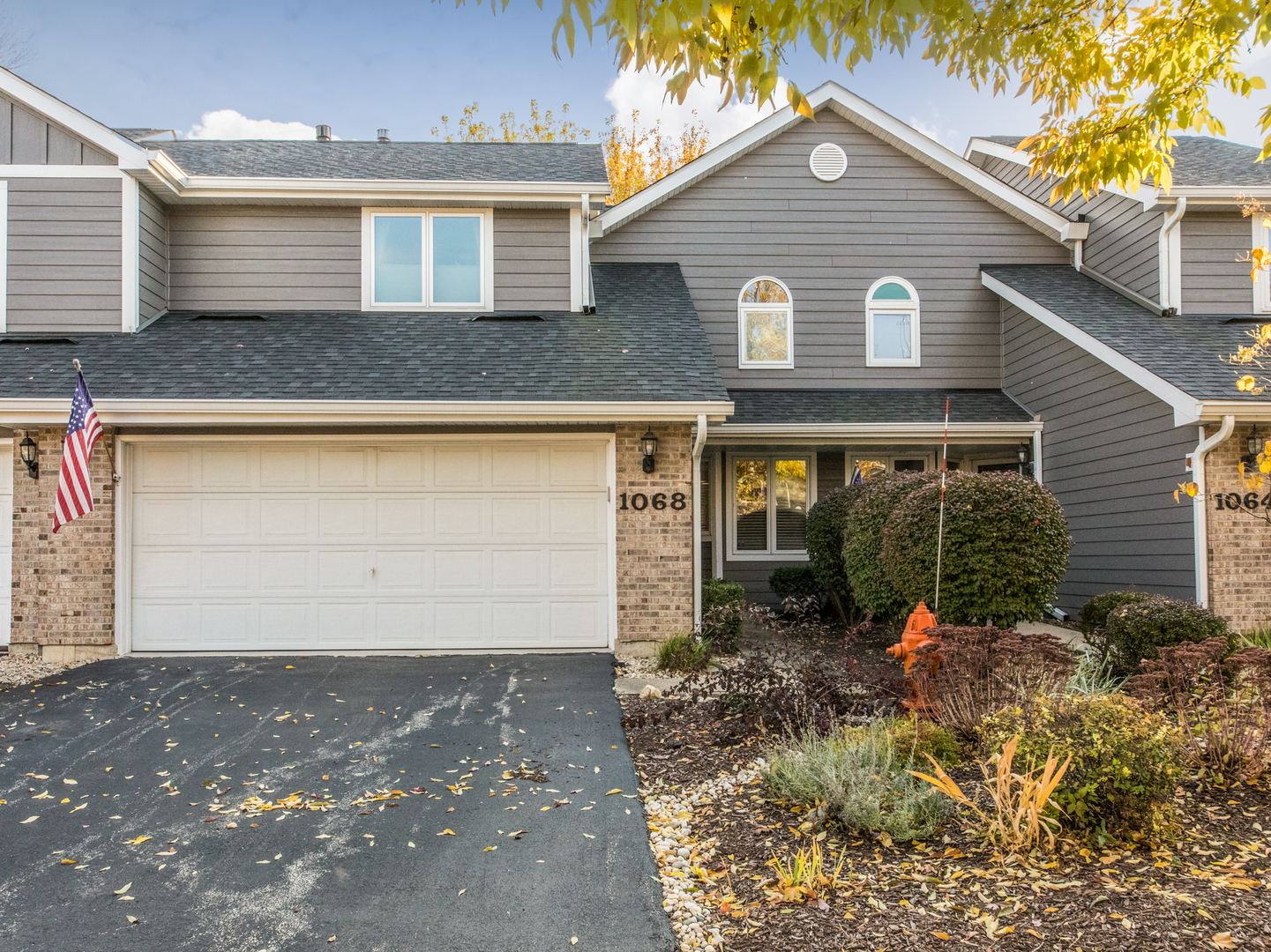 a view of a house with a small yard and plants
