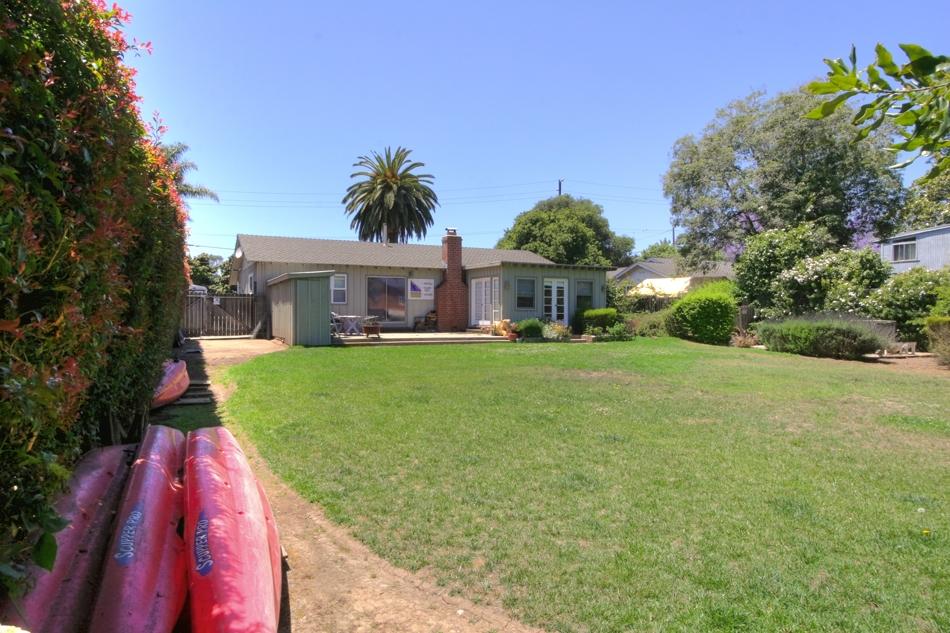 150 Toro Canyon Road Carpinteria, CA 93013 - Photo 6 of 10 a view of house in front of a big yard with large trees