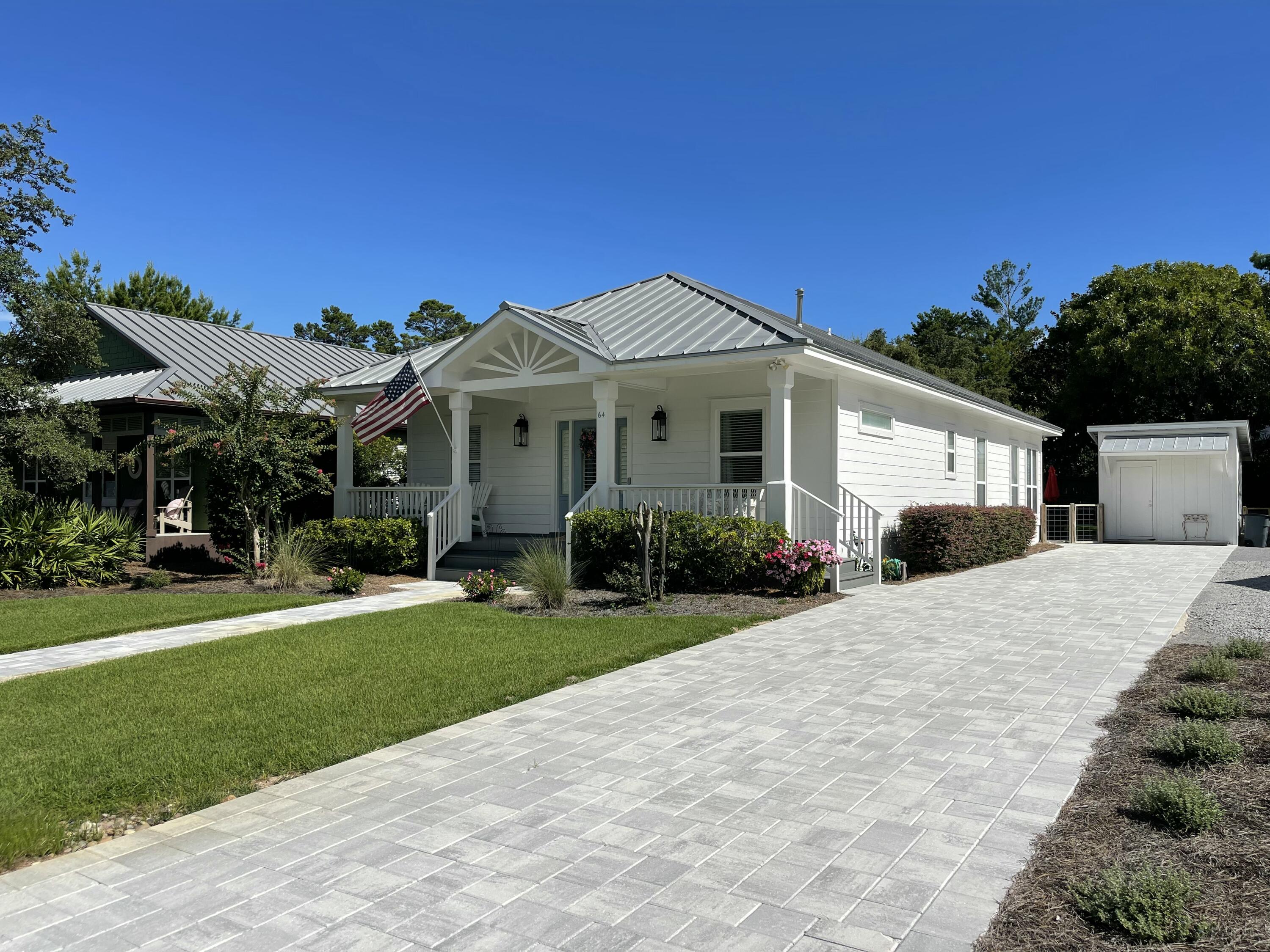 64 Spotted Dolphin Road Santa Rosa Beach, FL 32459 - Photo 34 of 43 a front view of a house with a yard