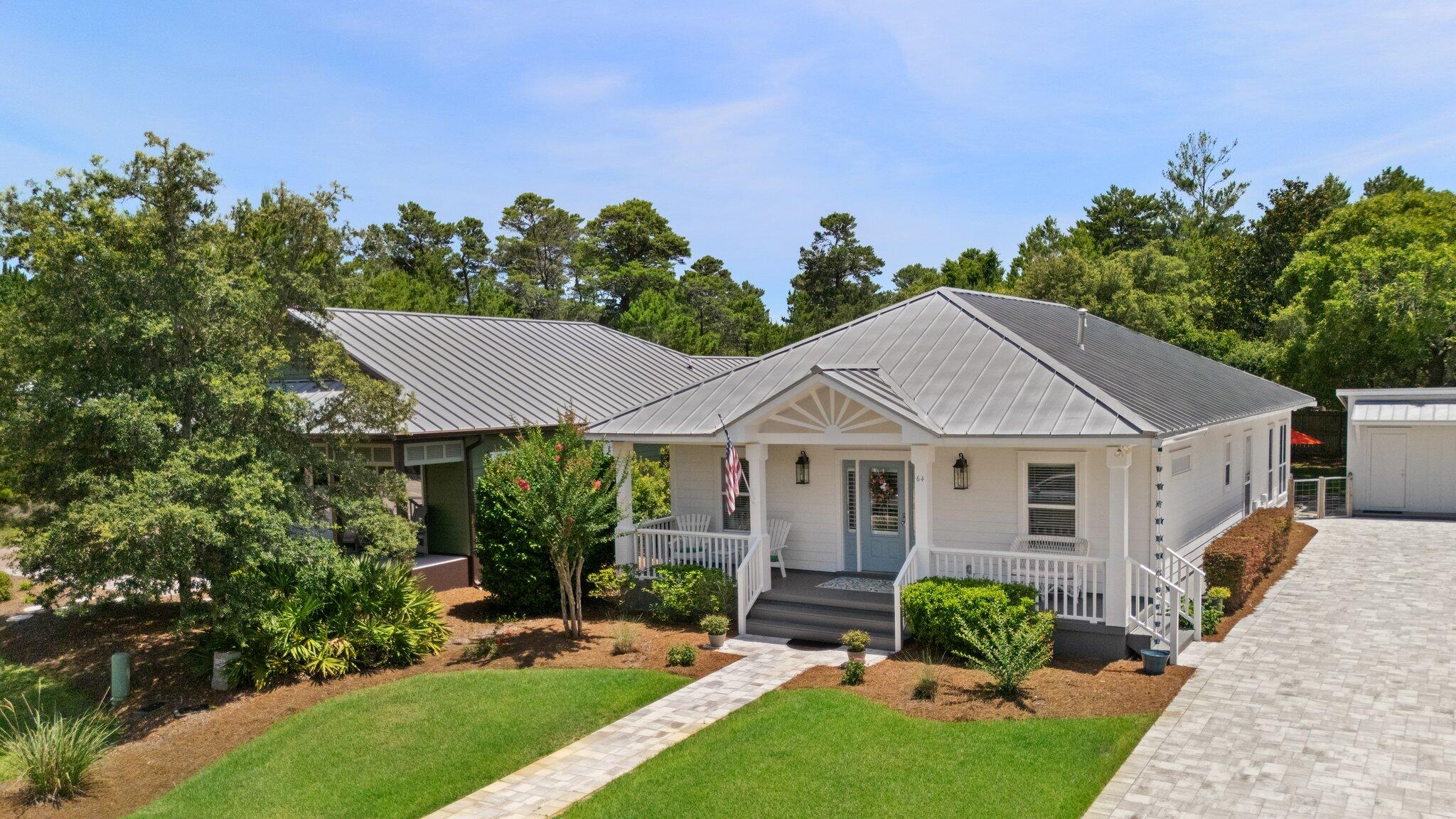 64 Spotted Dolphin Road Santa Rosa Beach, FL 32459 - Photo 42 of 43 a view of a house with a yard potted plants and a table