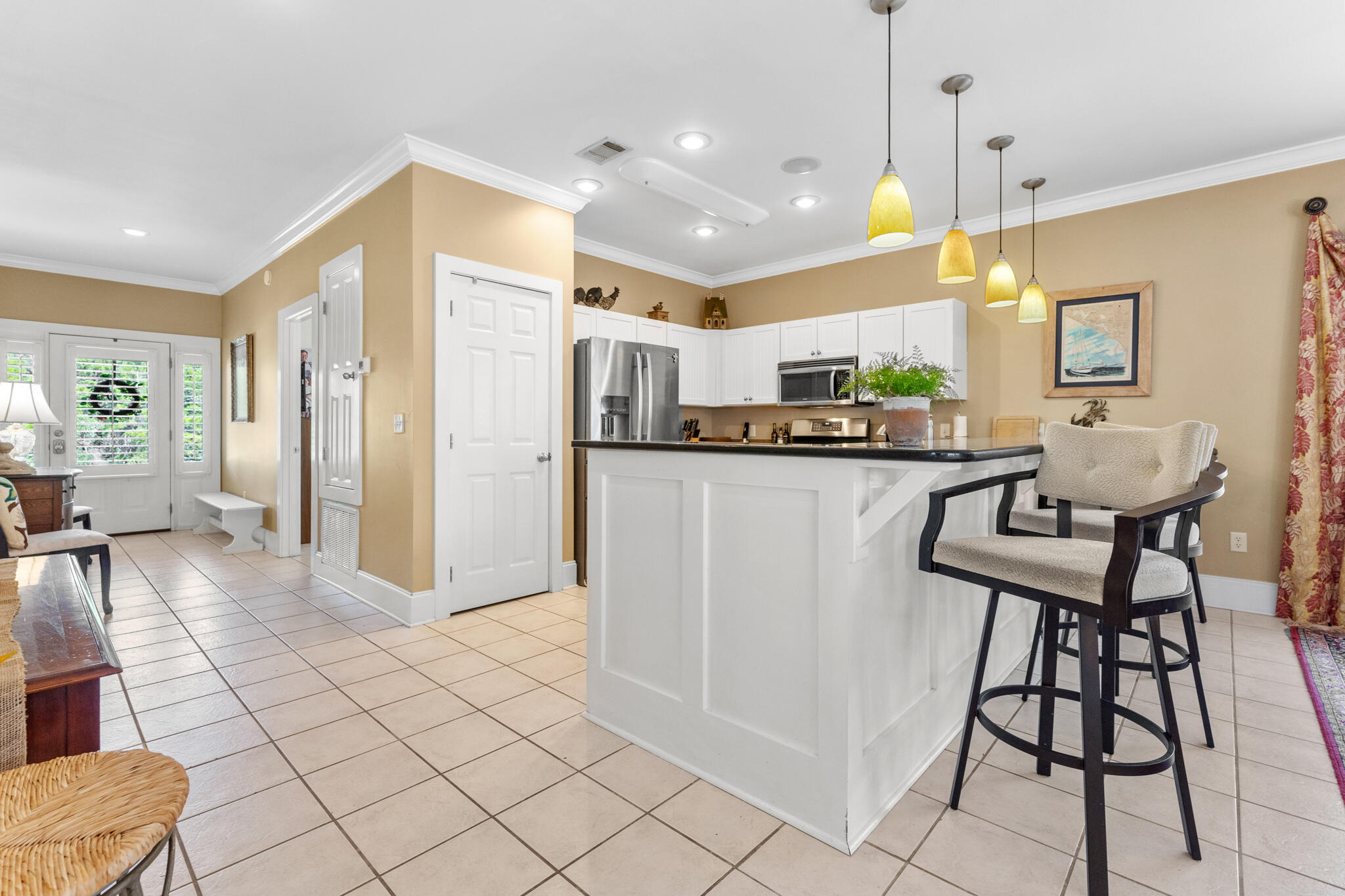 64 Spotted Dolphin Road Santa Rosa Beach, FL 32459 - Photo 6 of 43 a kitchen with stainless steel appliances kitchen island granite countertop a refrigerator and microwave