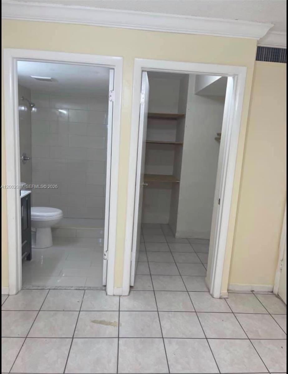6795 Southwest 132nd Avenue, Unit 203 Miami, FL 33183 - Photo 3 of 9 a bathroom with a toilet and a shower