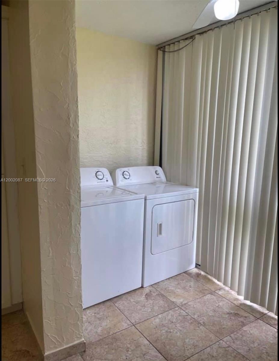 6795 Southwest 132nd Avenue, Unit 203 Miami, FL 33183 - Photo 4 of 9 a utility room with dryer and washer