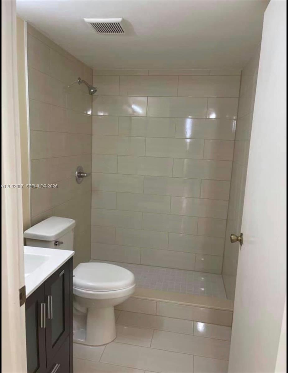 6795 Southwest 132nd Avenue, Unit 203 Miami, FL 33183 - Photo 6 of 9 a bathroom with a toilet a sink and shower