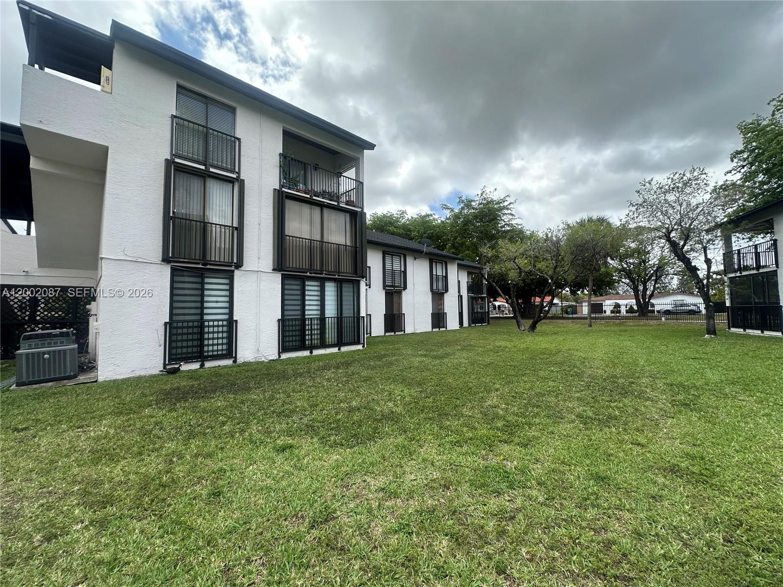 6795 Southwest 132nd Avenue, Unit 203 Miami, FL 33183 - Photo 8 of 9 a view of a house with backyard and trees