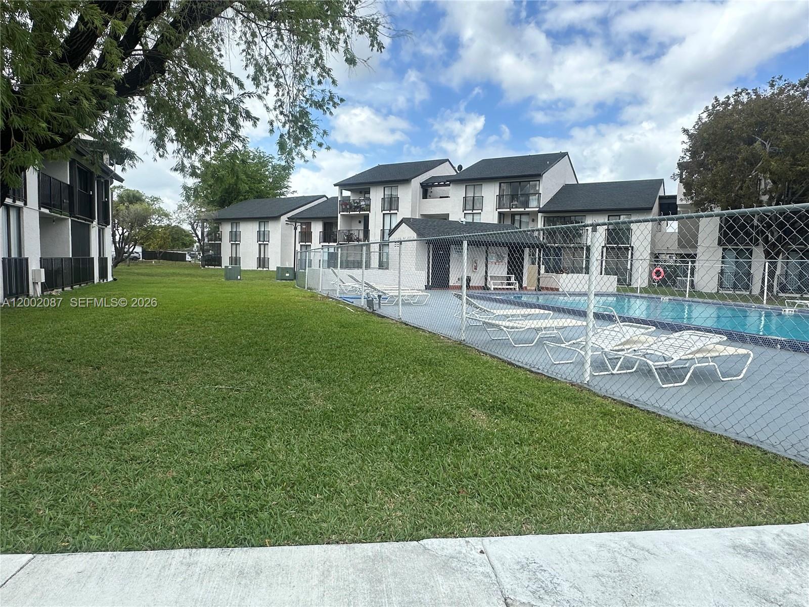 6795 Southwest 132nd Avenue, Unit 203 Miami, FL 33183 - Photo 9 of 9 a front view of a house with a garden