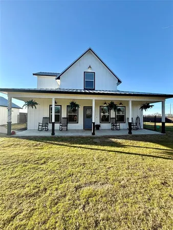 a view of a house with swimming pool and a yard