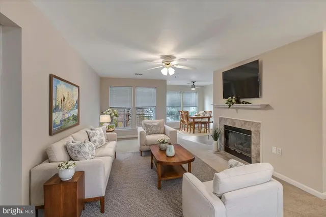 a living room with furniture a fireplace and a flat screen tv