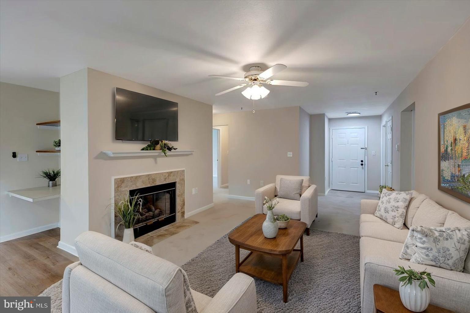 4828 Stone Shop Circle, Unit 4828 Owings Mills, MD 21117 - Photo 5 of 18 a living room with furniture a fireplace and a flat screen tv