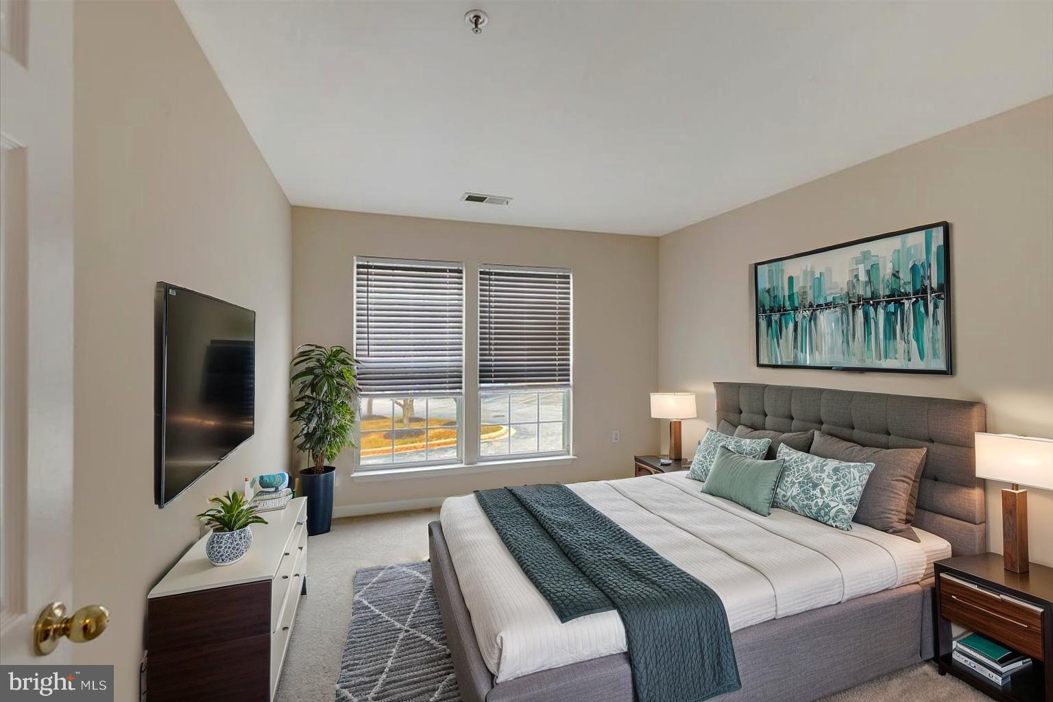 4828 Stone Shop Circle, Unit 4828 Owings Mills, MD 21117 - Photo 9 of 18 a bedroom with a balcony a bed and a flat screen tv