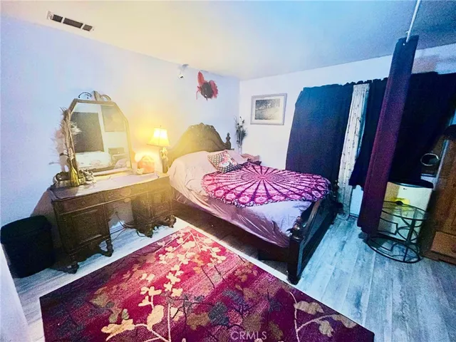 a bedroom with a bed and a mirror