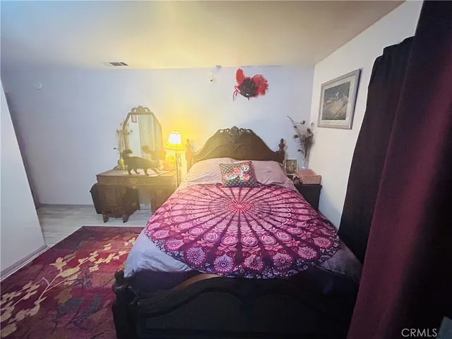 a bedroom with a bed and a rug