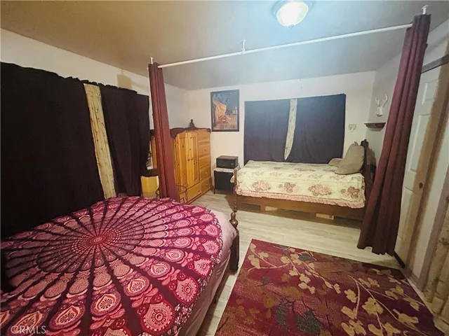 a bedroom with a bed and a mirror